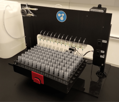 Photo of the Bartender device with rows of collection tubes loaded into a dispensing rack for automated fluid filling.
