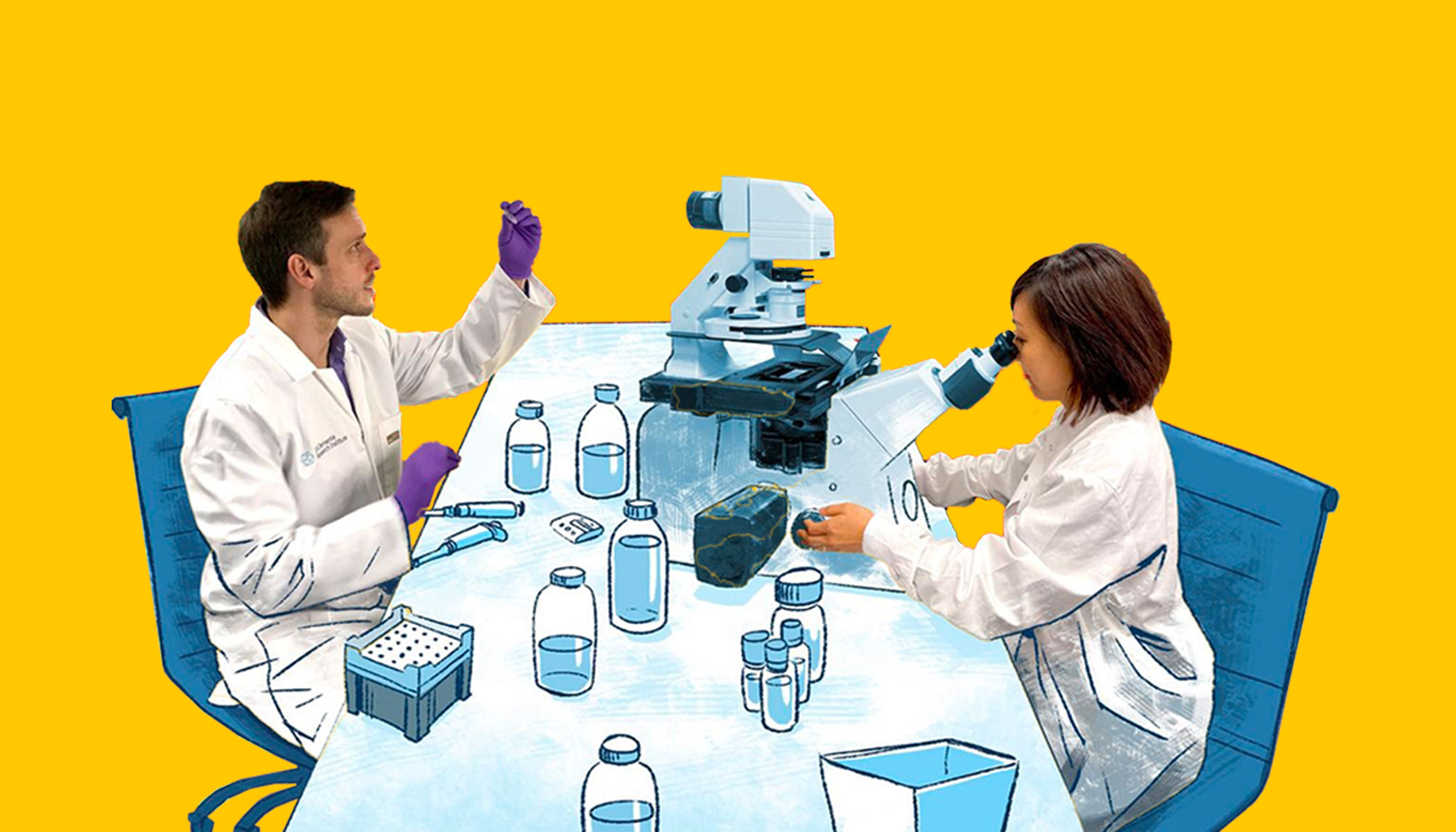 Two scientists work at a lab table and look at samples.