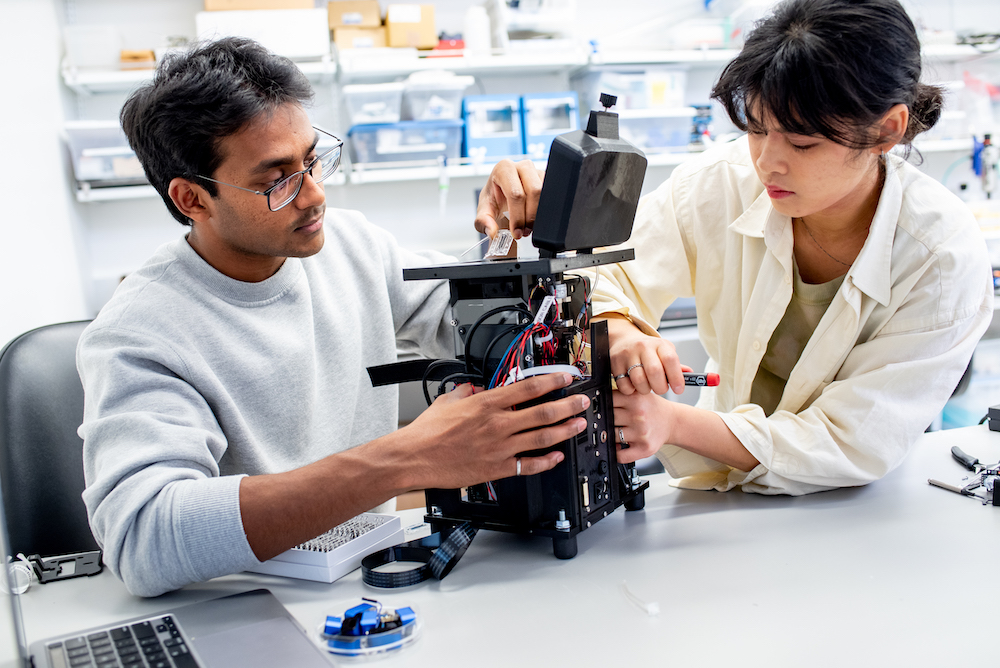 Biohub engineers make final adjustments to a prototype microscope for diagnosing malaria before it’s shipped to Uganda for field tests.