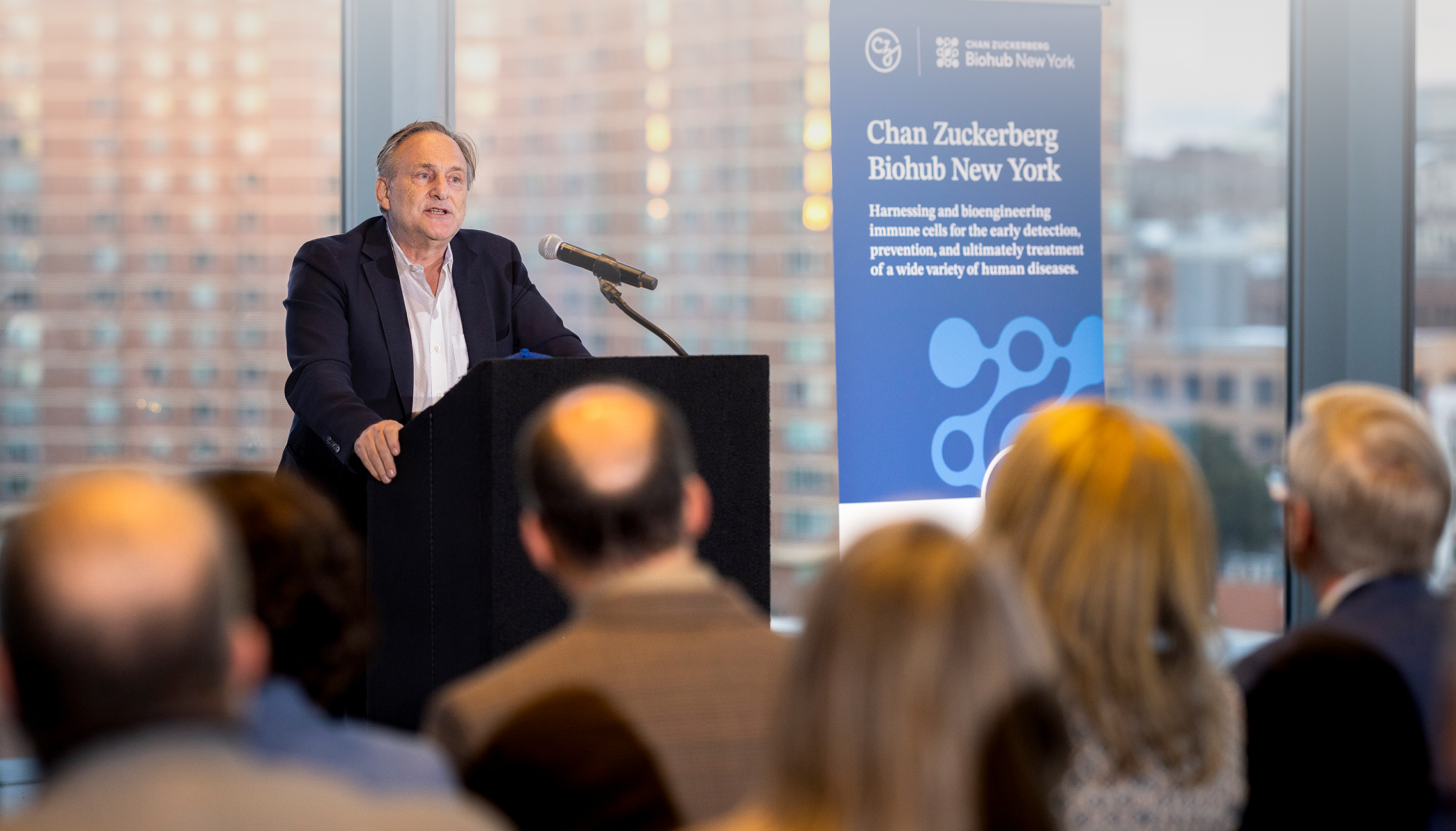 Andrea Califano, president of CZ Biohub NY stands at a podium.