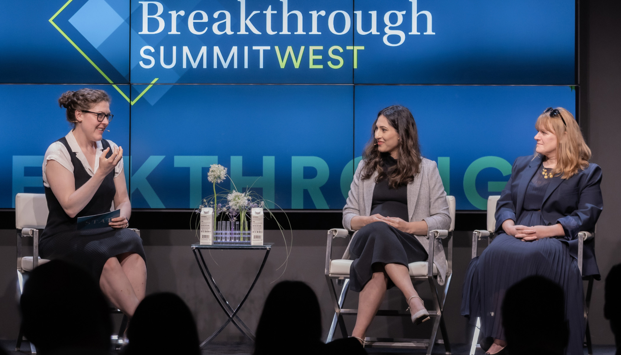 Katie Palmer, Gita Mahmoudabadi, and Patricia Brennan speak on stage at the 2025 STAT Breakthrough Summit West, seated in front of a large blue screen displaying the event logo.