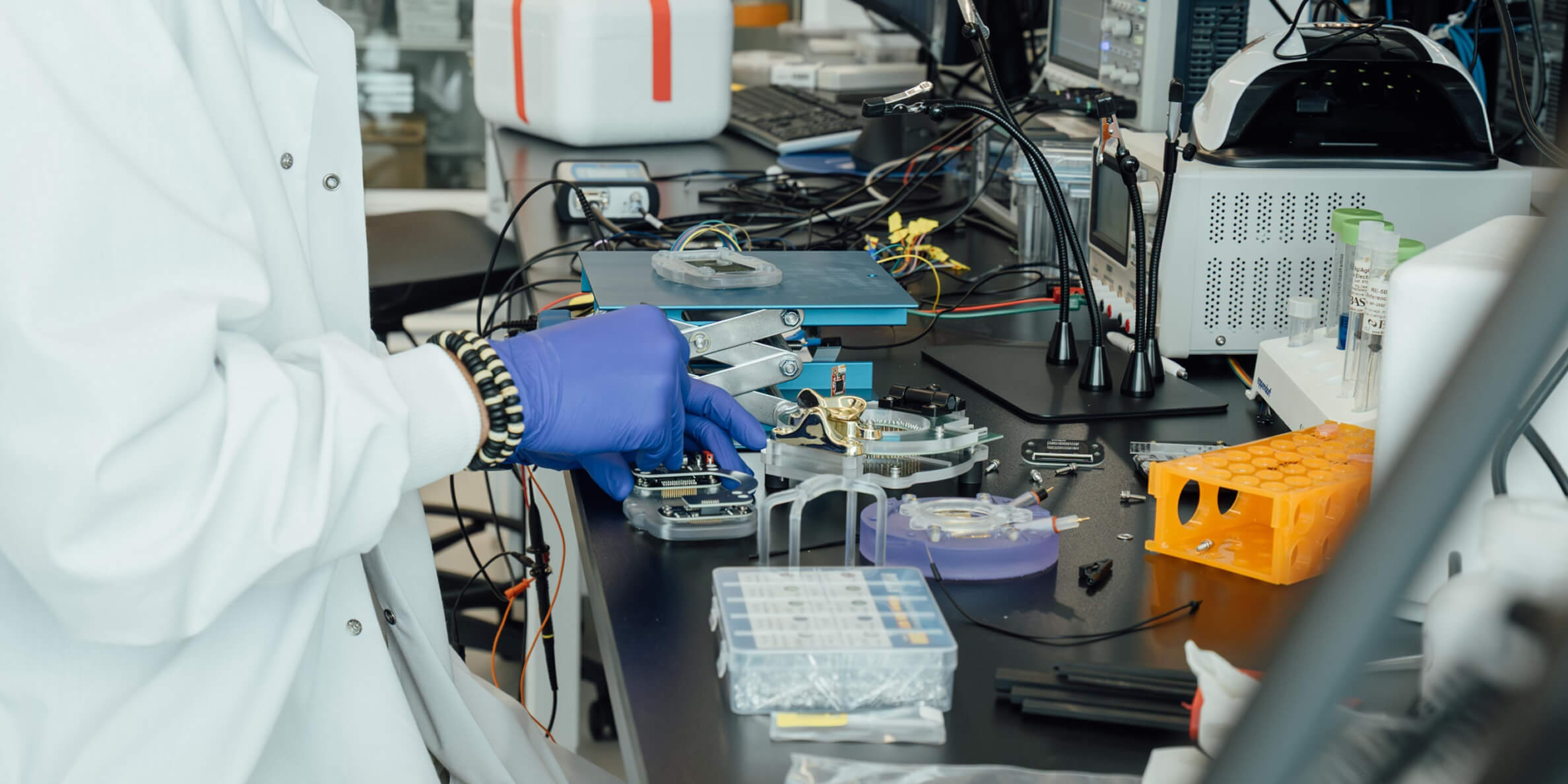 Researcher assembling scientific instruments and electronic components for bioengineering and medical research